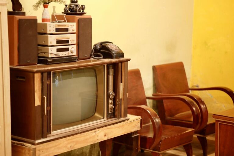 A nostalgic old-school living room with a vintage TV, stereo, and rotary phone reminiscent of the era before 1980.