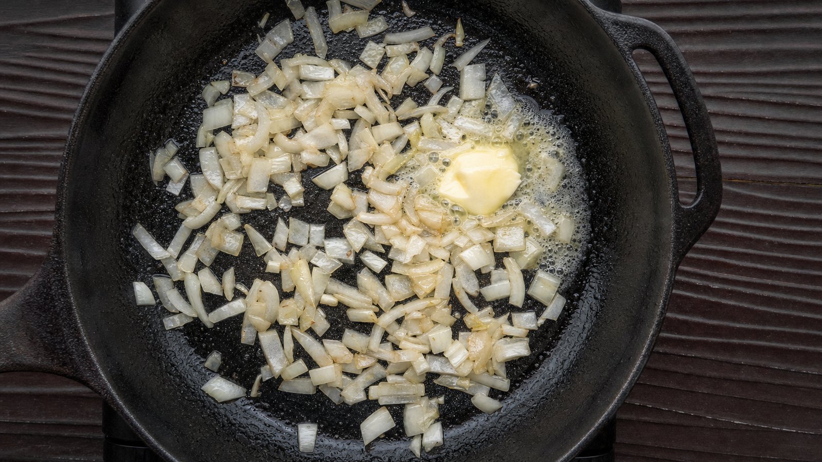 Baked Pork Chops with Apples and Onions: Reduce the heat to medium. Add the butter and onion and cook for 4 minutes, stirring, until starting to soften