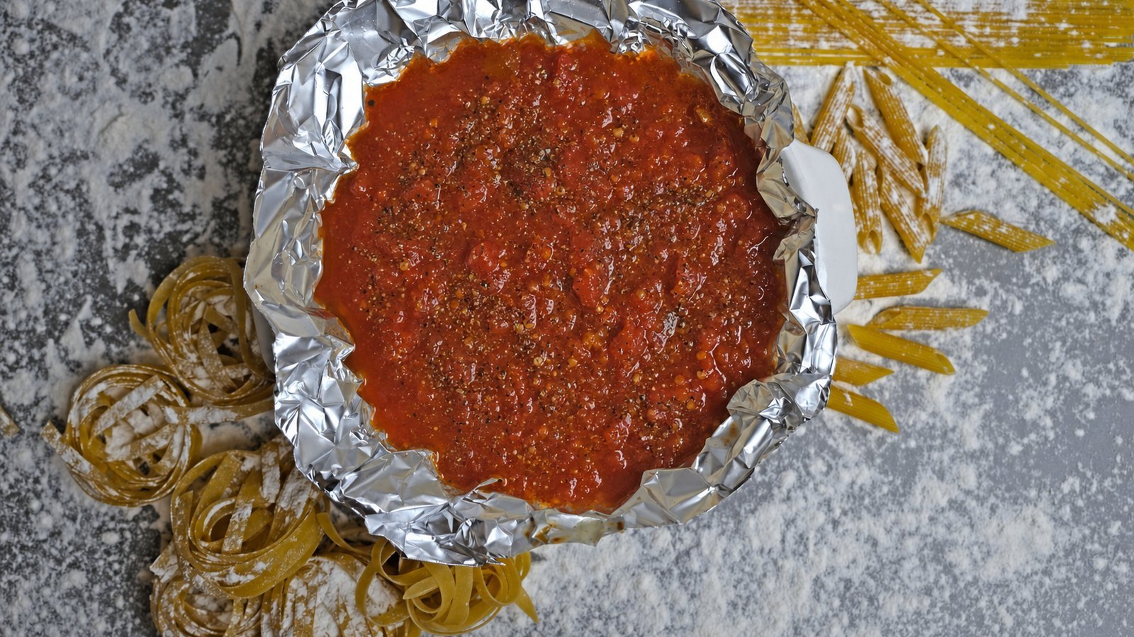 Baked Ziti: Pour in the crushed tomatoes and water. Season with salt and pepper and simmer for 15 to 20 minutes until slig