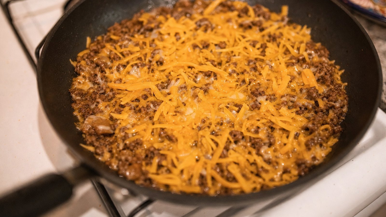 Cheeseburger Skillet: Turn off the heat. Stir in 1 1/2 cups of the cheddar until melted. Sprinkle the remaining 1/2 cup on top, cove