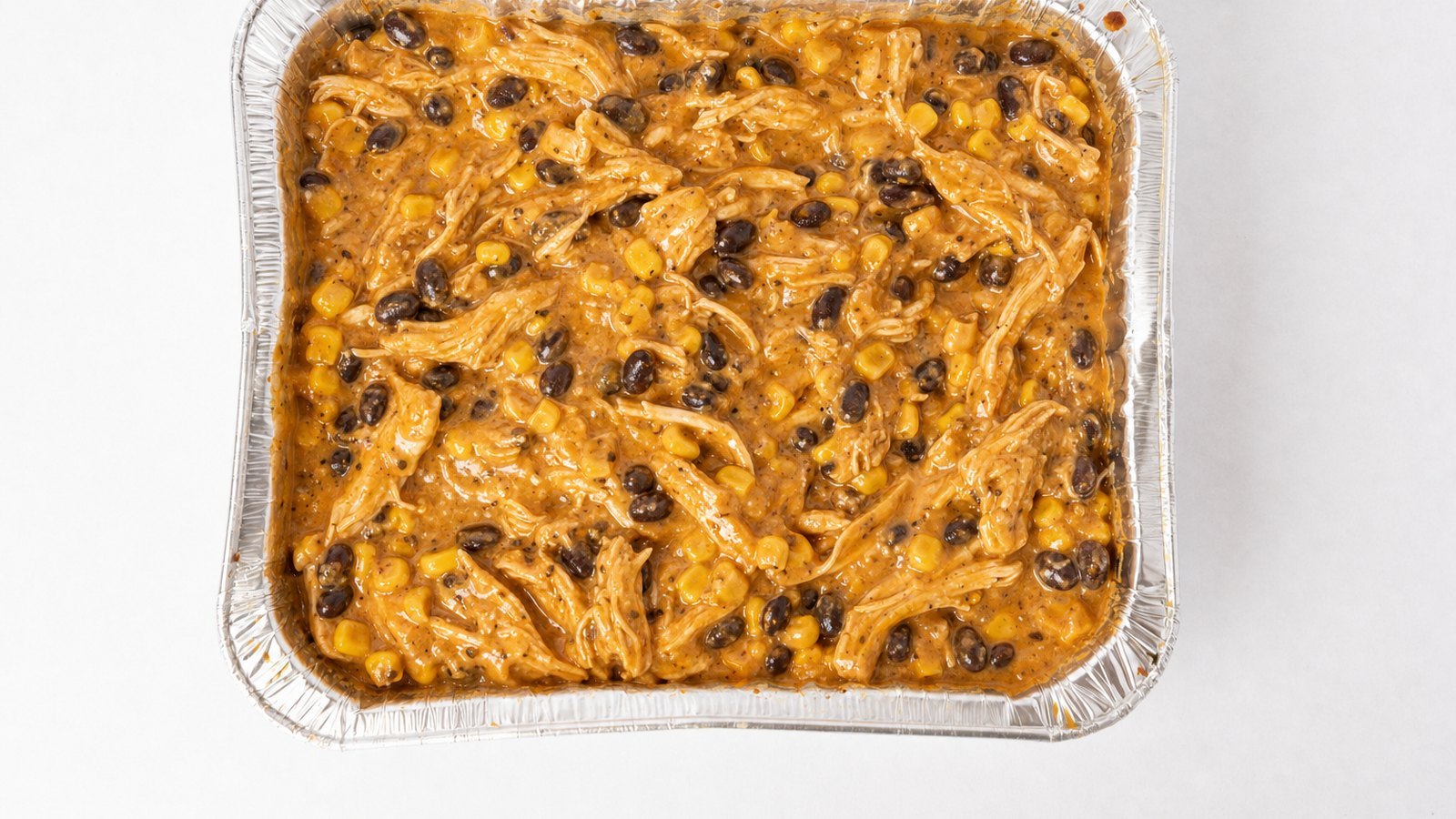 Chicken Enchilada Casserole: Add the chicken, black beans, corn, 1 cup of the enchilada sauce and the cream cheese. Stir for 2 to 3 minutes