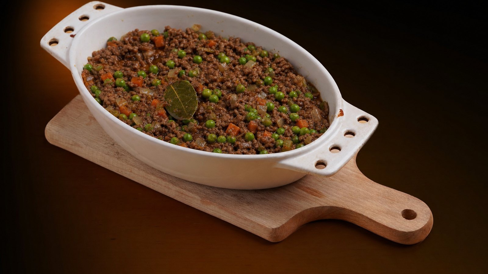 Cottage Pie: Stir in the peas, salt and pepper. Taste and adjust. Remove the bay leaf and spread the filling in a greased 9