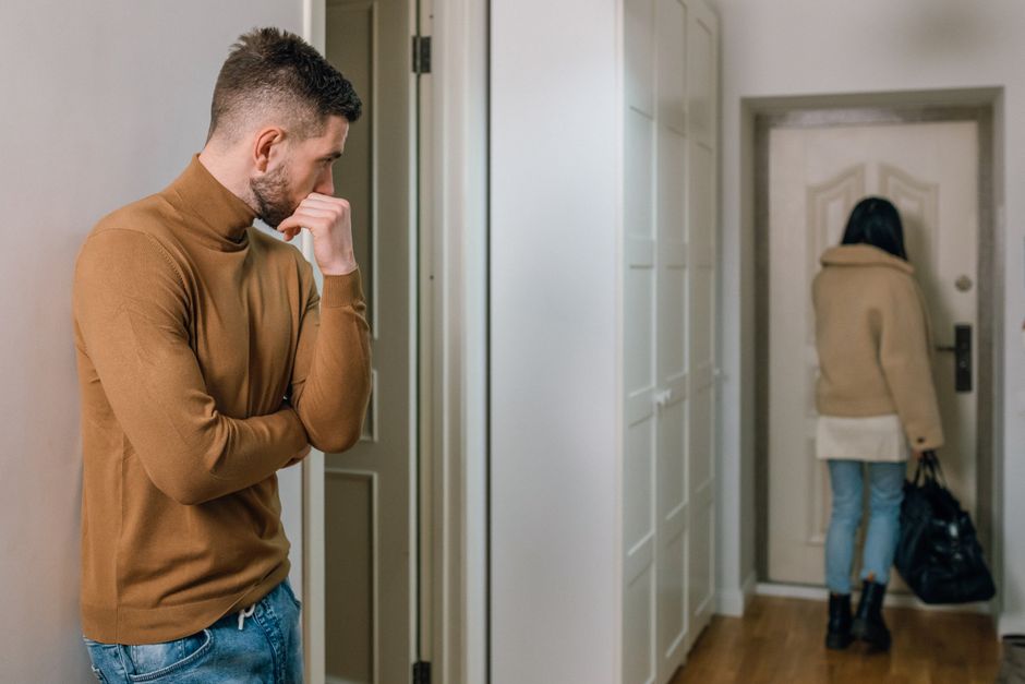 A man pauses to reflect as his partner steps away, illustrating that love sometimes means allowing space and distance.