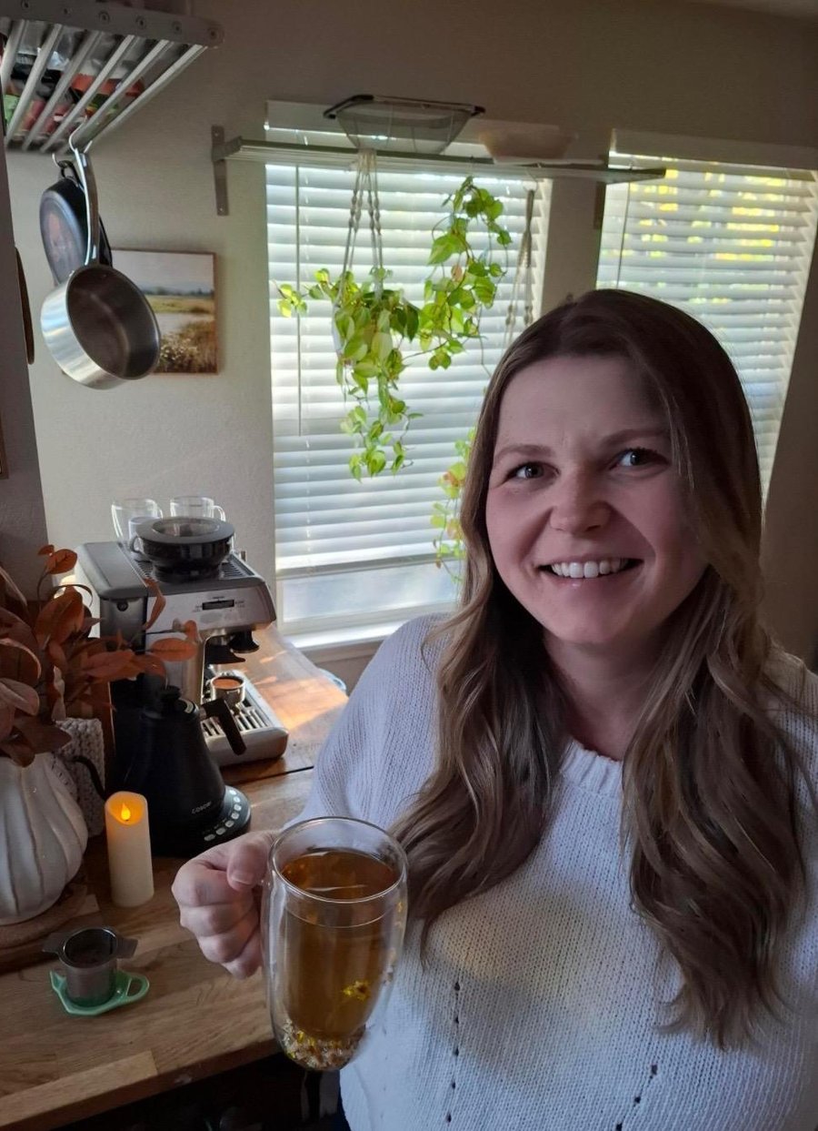 Isabel Bernard smiling with a cup of tea in her kitchen
