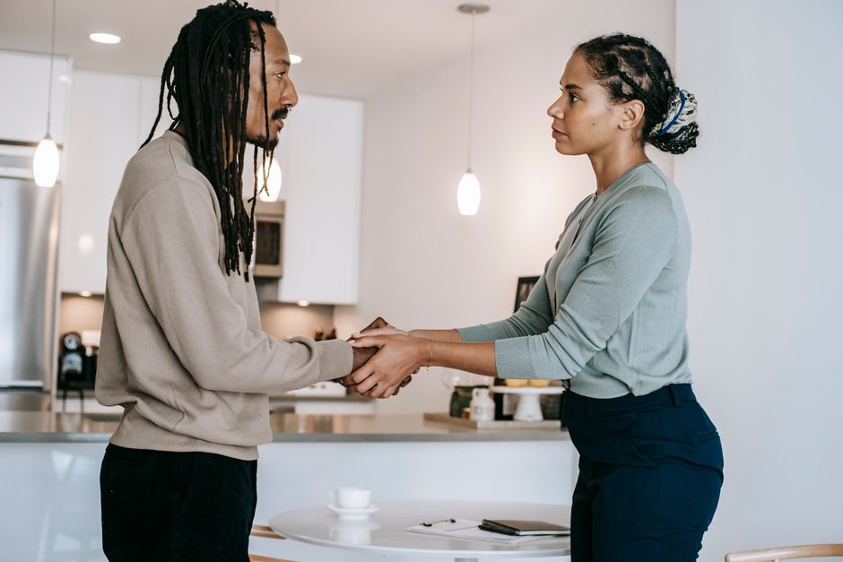 Two people holding hands and meeting each other's gaze, representing genuine connection and understanding in life.
