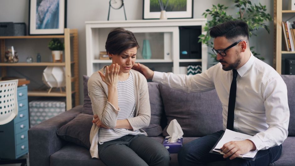A woman receives comforting support from a professional counselor, illustrating that seeking help in tough times is a sign of strength, not failure.