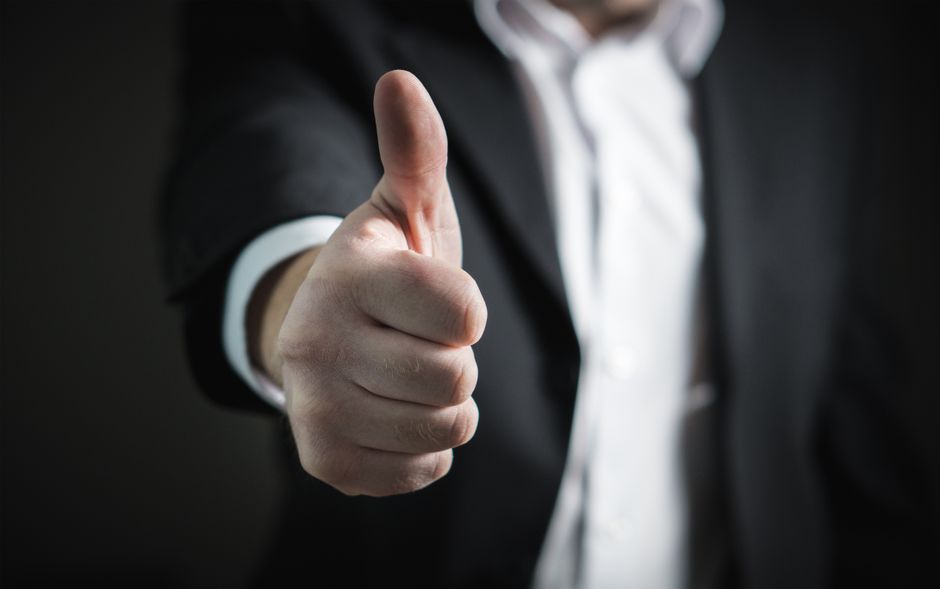 A thumbs-up gesture symbolizing the old-school way of saying "right on" to show agreement.