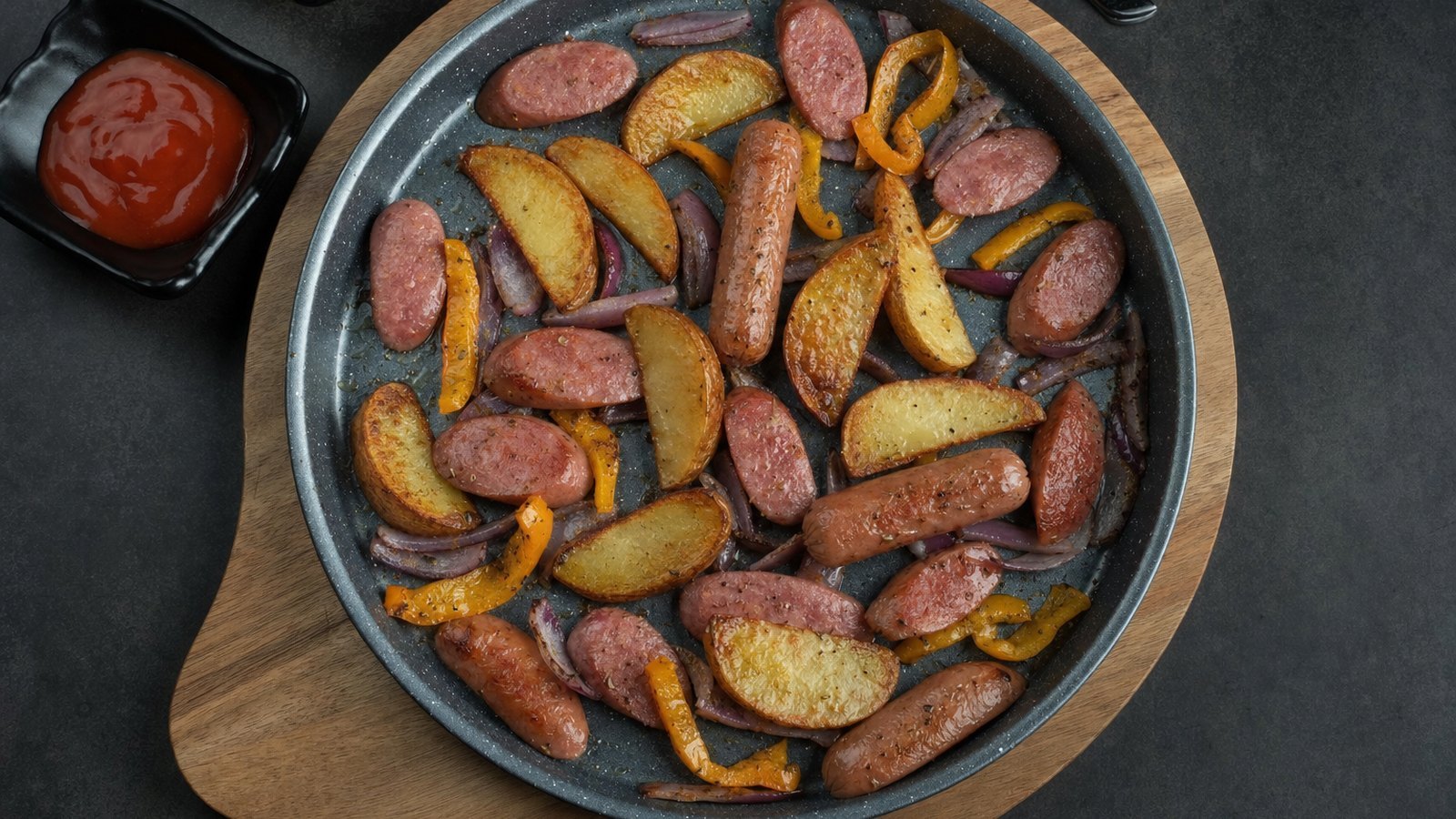 Sheet Pan Sausage and Vegetables: Carefully remove the hot pan, spread the potatoes on it cut side down and roast for 15 minutes