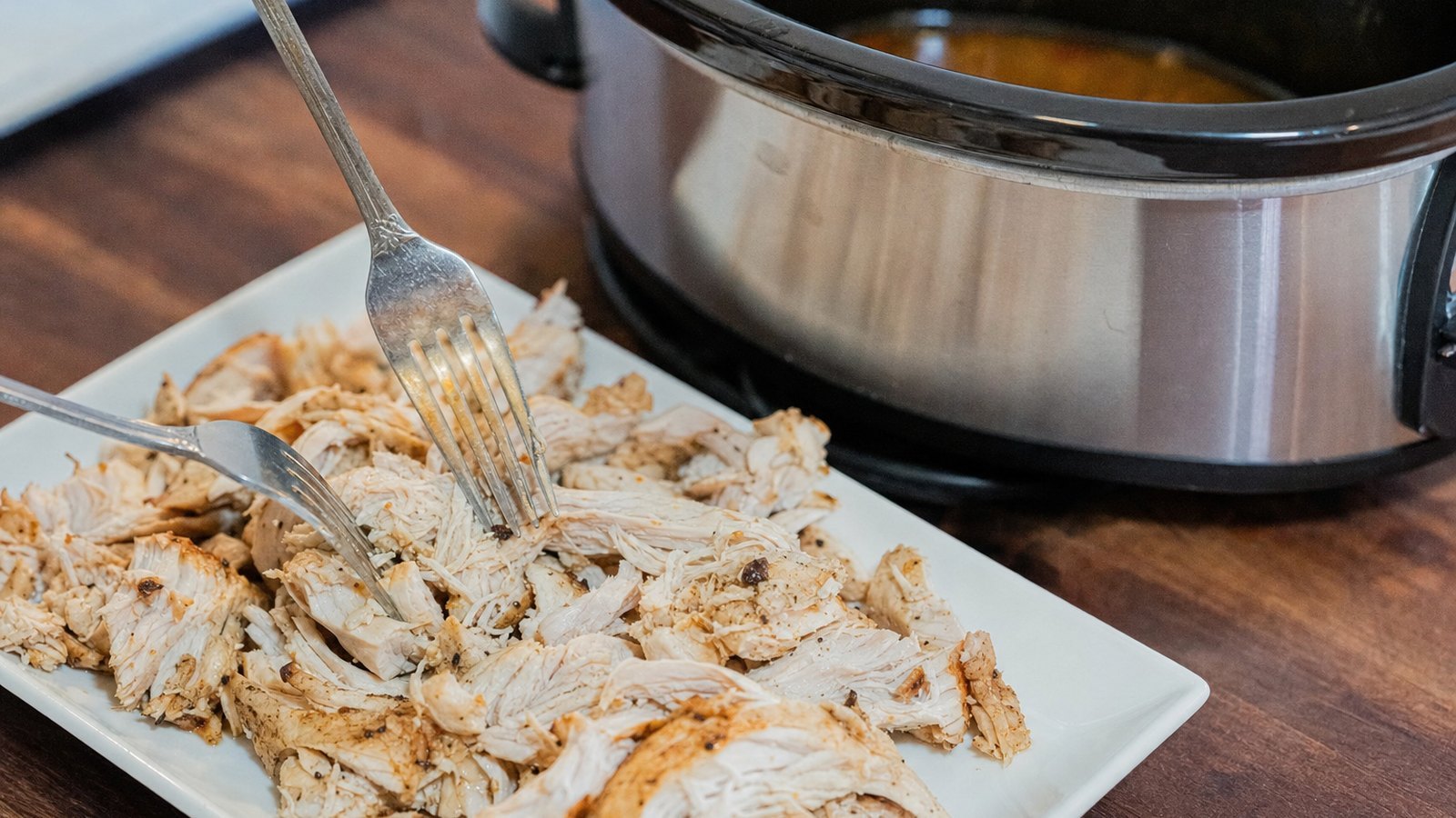 Slow Cooker Chicken Tacos: Transfer the chicken to a cutting board and shred with two forks. Meanwhile, set the cooker to HIGH with the l