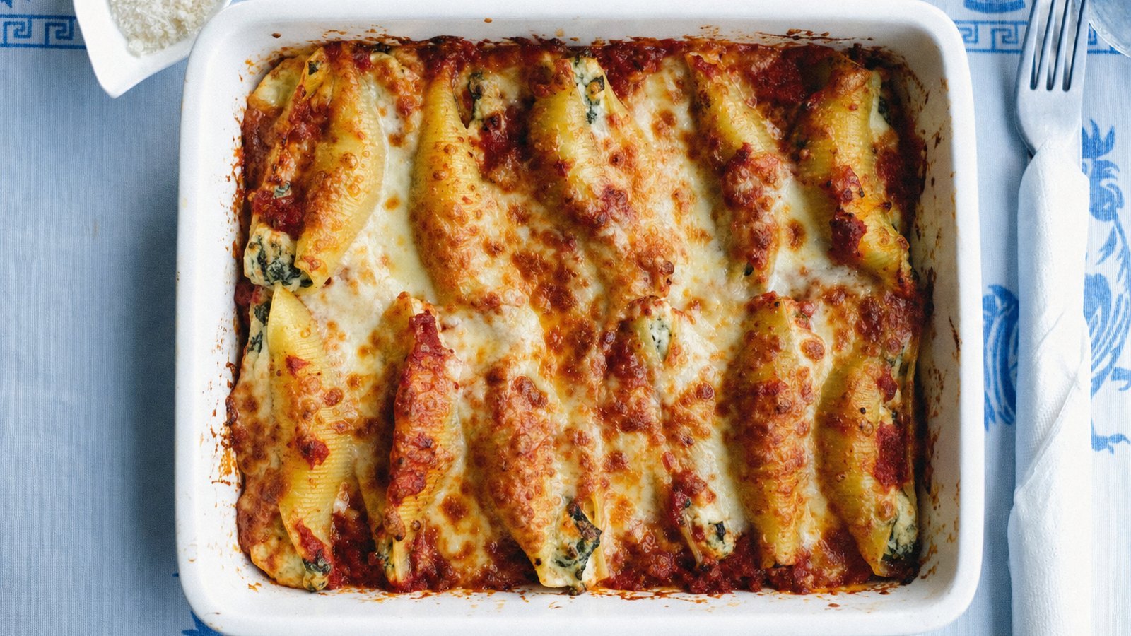Stuffed Shells with Spinach and Ricotta: Bake covered for 25 minutes. Remove the foil and bake 10 to 15 minutes more, until the sauce bubbles and the c
