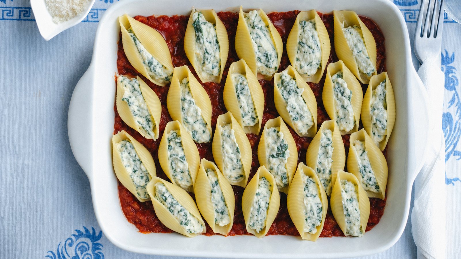 Stuffed Shells with Spinach and Ricotta: Spoon about 2 tbsp of filling into each of 24 shells and arrange them open side up in the sauced dish in a sin