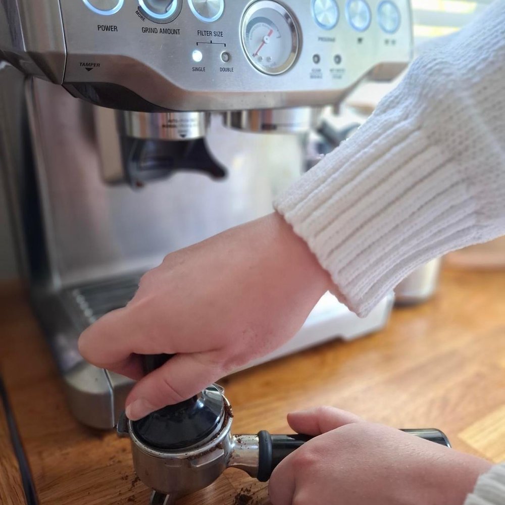 Tamping fresh espresso grounds