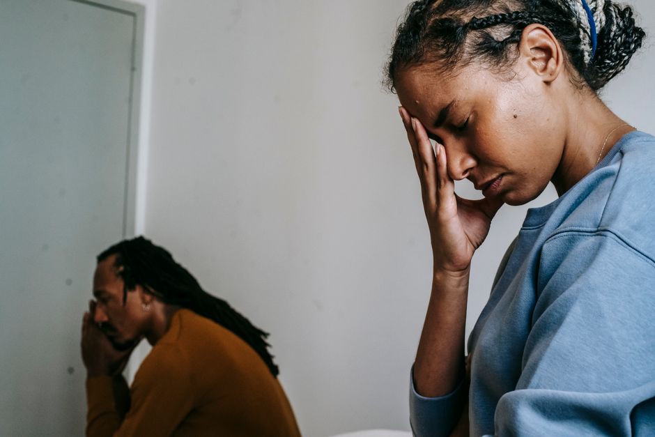 Exhausted couple showing signs of fatigue after an argument, illustrating how tiredness often fuels conflict more than the actual disagreement.