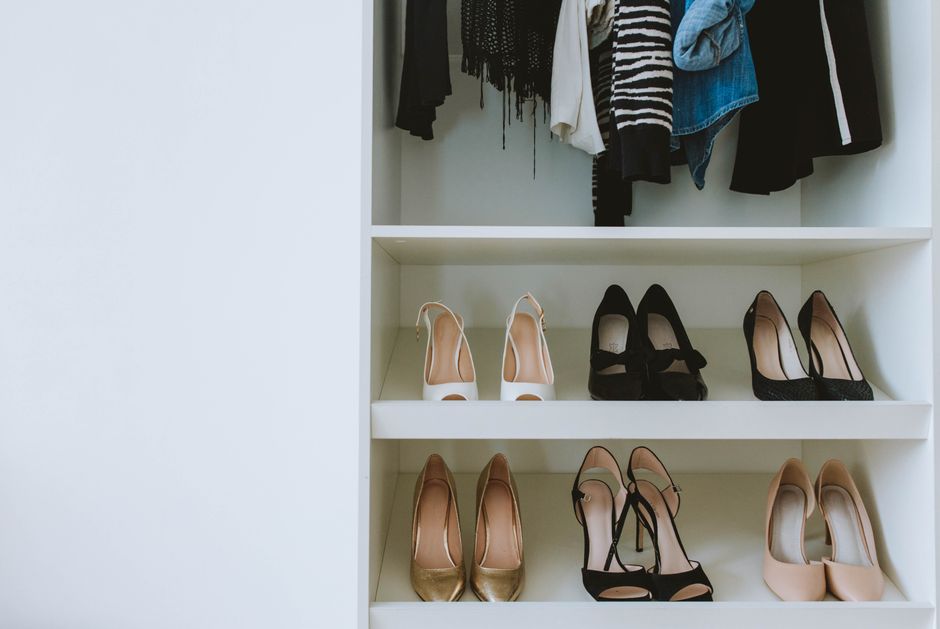 A row of unworn high heels sitting on a closet shelf, left behind in favor of comfort.